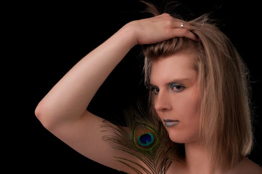 Young woman with peacock feather