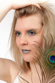 Young woman with peacock feather