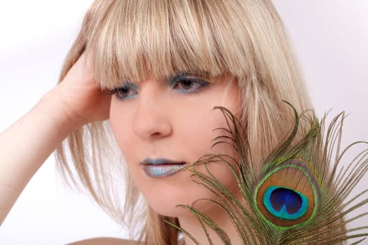 Young woman with peacock feather