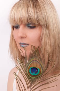 Young woman with peacock feather