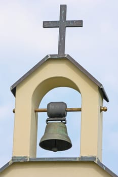 Old bell on a little steeple in the small cemetery