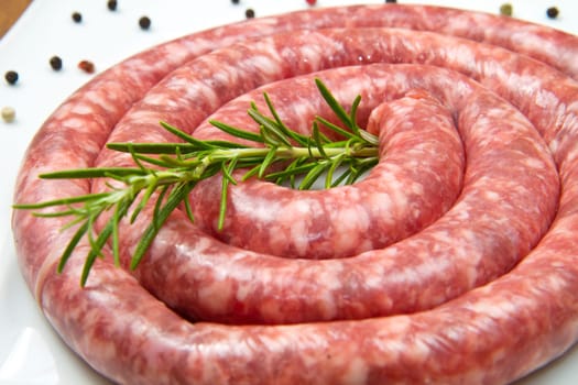 fresh raw sausage with rosemary and pepper