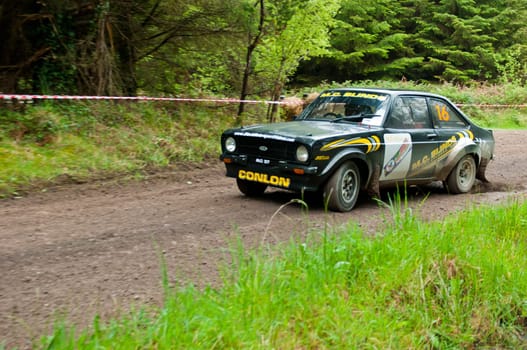 MALLOW, IRELAND - MAY 19: M. Conlon driving Ford Escort at the Jim Walsh Cork Forest Rally on May 19, 2012 in Mallow, Ireland. 4th round of the Valvoline National Forest Rally Championship.