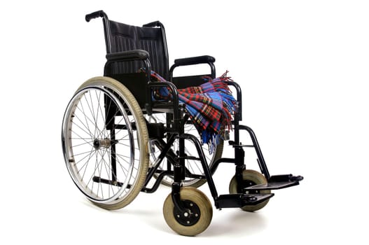 Wheelchair with blanket isolated in white background