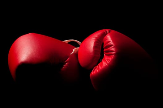 Boxing gloves against a black backgroud