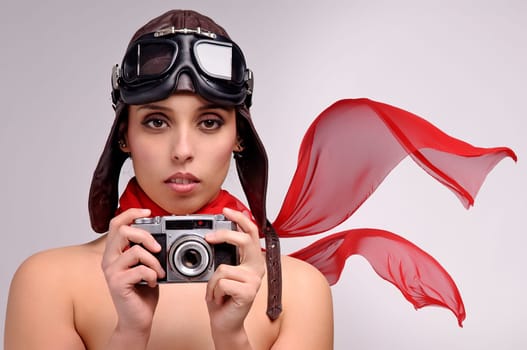 Beautiful girl with helmet and goggles and a camera