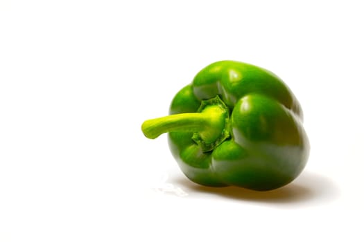 Green paprika (pepper) isolated on a white background. Horizontally.