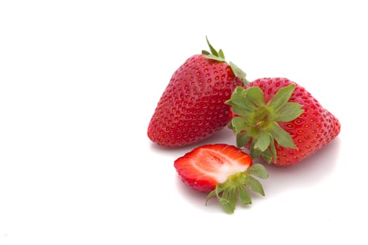 Beautiful two  strawberries and one half isolated on white