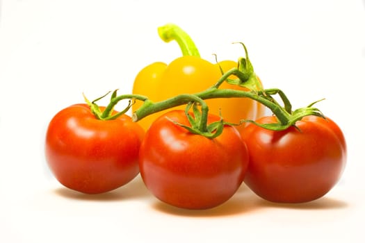 Group bush tomatoes and fresh yellow pepper in the background.