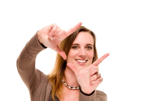 Laughing woman shapes frame with her hands against white background
