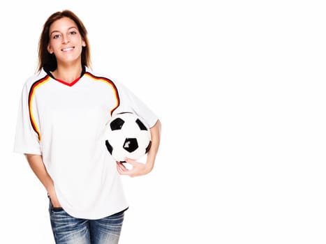 Happy young woman with soccer ball wearing jersey against white background