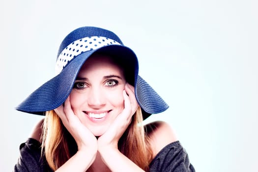 Happy woman with summer hat against light background
