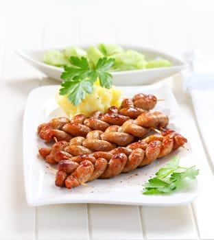 Bratwurst - fried sausage with mashed potatoes and cucumber salad