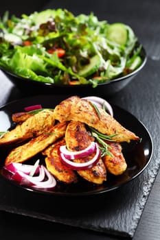 Marinated Indian chicken breast stripes with salad