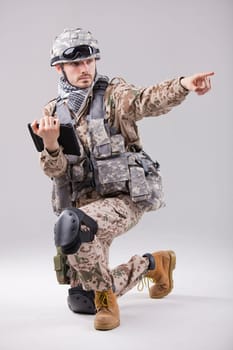 Soldier or commander holding tablet computer and pointing with a finger