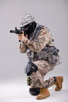 Soldier special forces with machine gun in a white studio