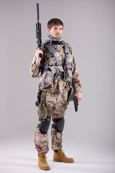 Portrait of Armed Soldier with two guns in a white studio