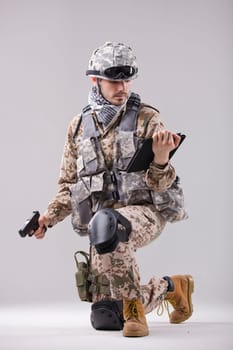 Modern soldier with handgun and tablet computer
