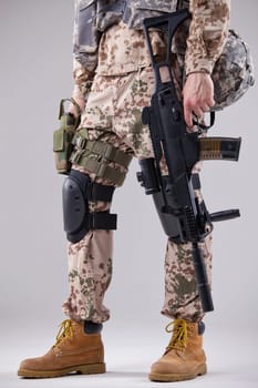 armed soldier with machine gun in white studio
