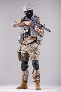 Military man, terrorist or soldier in camouflage with machine gun
