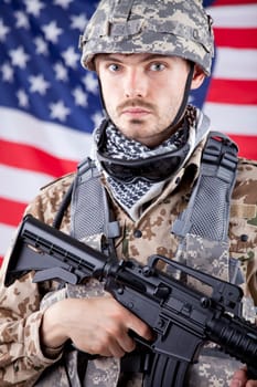 Portrait of armed American soldier over american flag in background