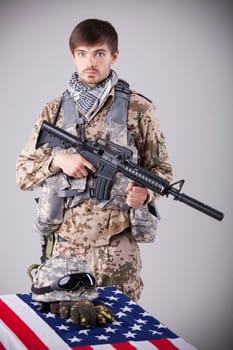 Fallen soldier memorial - sad soldier with machine gun on funeral