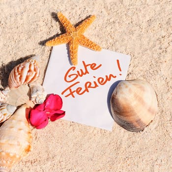 blank paper on white sand beach with starfish and shells like summer vacation background