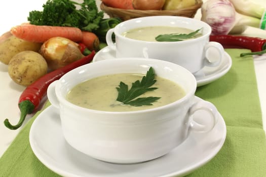 two cups of vegetable cream soup with parsley