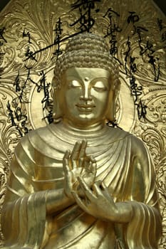 Bronze icon blessing Buddha in serene mood