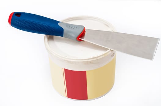 scraper and can of putty to repair cracks