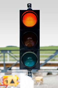 One of traffic light signal shows yellow light