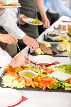 Business catering people take buffet food during company event