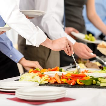 Business catering people take buffet food during company event