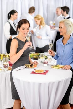 Business women drink aperitif during company seminar meeting