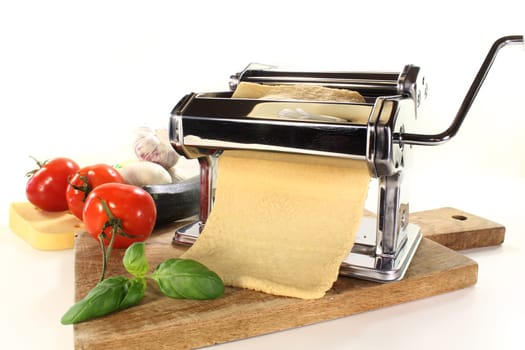 a pasta machine with homemade pasta dough