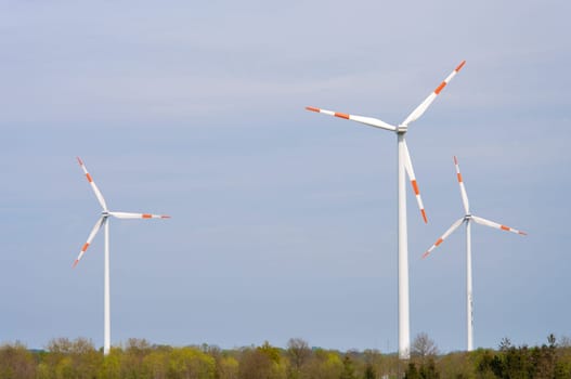 several windmills in a rural landscape