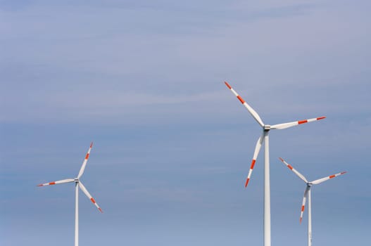 several windmills against a blue sky