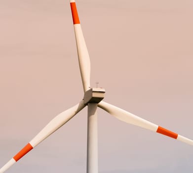 closeup of a windmill with red and white blades