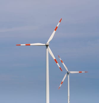 two windmills against a blue sky