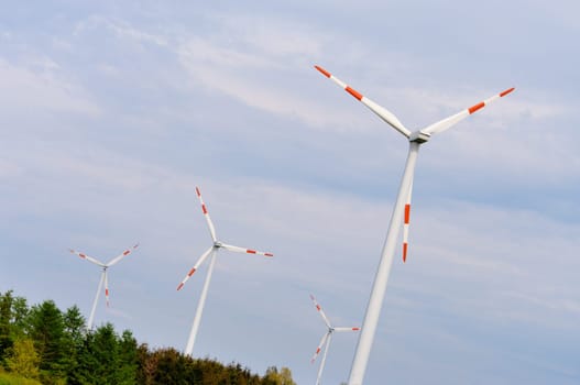 several windmills against a blue sky