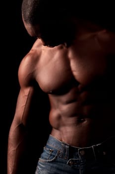Beautiful and muscular black man in dark background