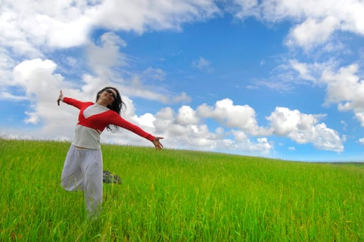 Happy woman in a green field