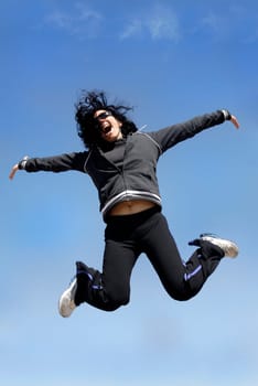 Woman jumping high outdoors