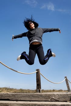 Woman jumping high outdoors