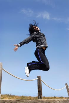 Woman jumping high outdoors
