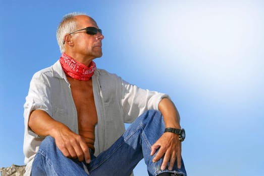 Handsome mature man adventurer posing outdoors