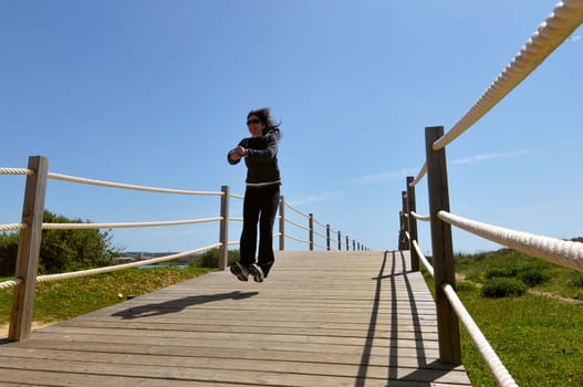 Woman jumping high outdoors