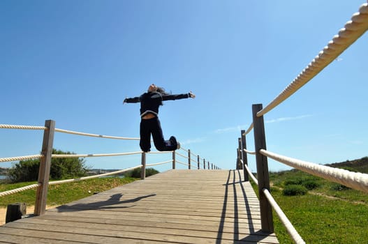Woman jumping high outdoors