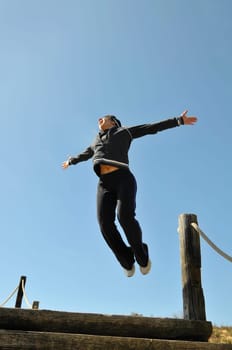 Woman jumping high outdoors