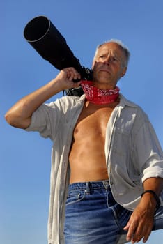 Handsome mature man photographer posing outdoors
